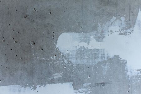 Puttying the wall with white putty, concrete wall with smeared irregularities, apartment repairの写真素材