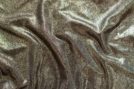 Abstract background of bright shiny silvery fabricの写真素材