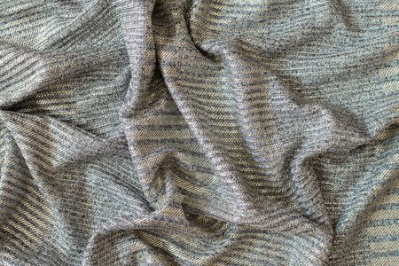 Abstract background of bright shiny silvery fabricの写真素材