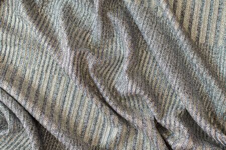 Abstract background of bright shiny silvery fabricの写真素材