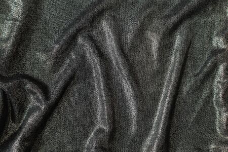 Abstract background of bright shiny silvery fabricの写真素材