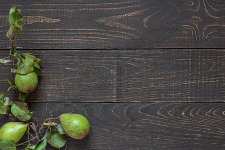 Fresh organic green pears with leaves on a natural brown wooden backgroundの写真素材