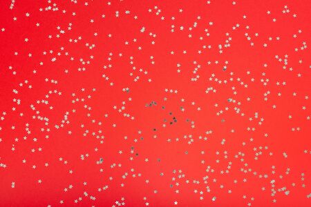 Festive background , red background with glitter silver stars, flat lay, top viewの写真素材