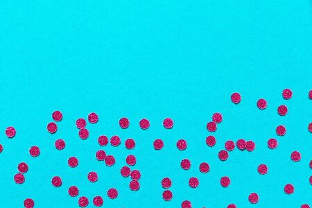 Bright pink round confetti on a blue background, holiday backgroundの写真素材