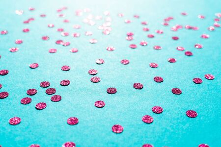 Bright pink round confetti on a blue background, holiday backgroundの写真素材