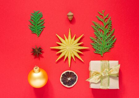 Holiday background ,set of christmas decorations, gift box and gold star with christmas ball, star anise with thuja twigs, acorn and dry citrus ,flat lay, top viewの写真素材