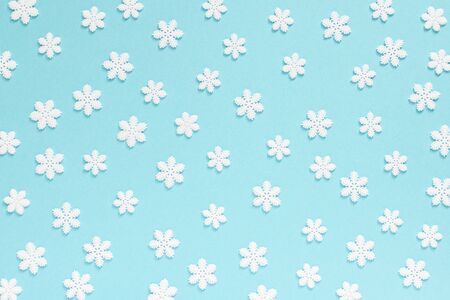 Holiday pastel background, white snowflakes on a gentle blue background ,flat lay, top viewの写真素材