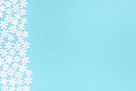 Holiday pastel background, white snowflakes on a gentle blue background ,flat lay, top viewの写真素材
