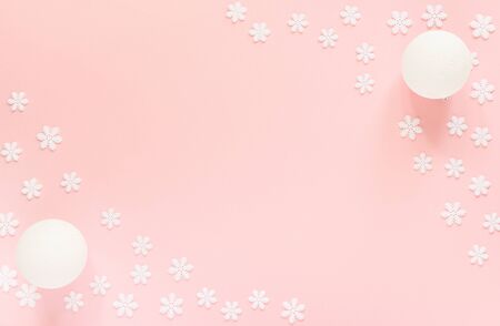 Holiday pastel background, white snowflakes and christmas ball on a gentle pink background ,flat lay, top viewの写真素材