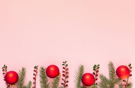 Holiday background , spruce branches and christmas balls on a pink background , flat lay, top viewの写真素材