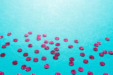 Bright pink round confetti on a blue background, holiday backgroundの写真素材