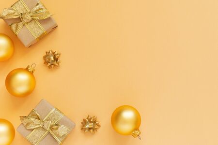 Festive background with gold decoration, gold background with gift boxes and christmas balls, flat lay, top view, copy spaceの写真素材