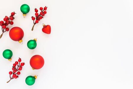 Festive background, branch of hawthorn and Christmas tree balls on a white background, flat lay, top view, copy spaceの写真素材