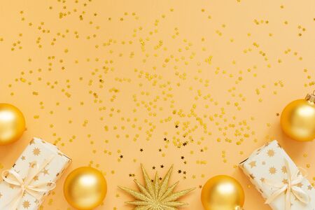 Festive background, gift boxes and christmas balls on background with glitter gold stars, flat lay, top view, copy spaceの写真素材