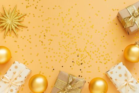 Festive background, gift boxes and christmas balls on background with glitter gold stars, flat lay, top view, copy spaceの写真素材