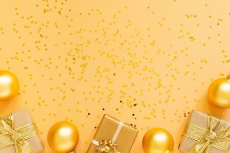 Festive background, gift boxes and christmas balls on background with glitter gold stars, flat lay, top view, copy spaceの写真素材