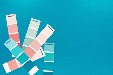Selection of palette for painting, sample color catalog on a turquoise green background, different shades of pink and green colorsの写真素材