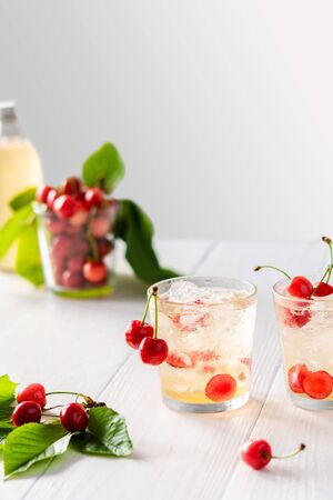 Refreshing summer sweet cherries drink, cocktail with ice and cherryの写真素材