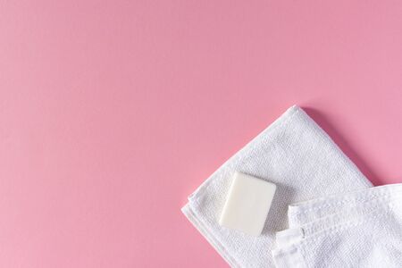 White towel with soap on a pink background, bath spa accessoriesの写真素材