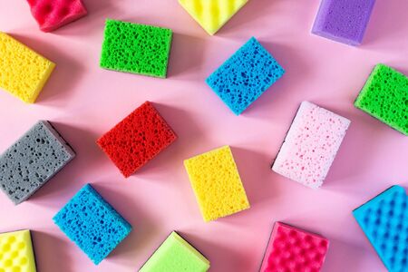 Pattern of multi-colored cleaning sponges on a pink backgroundの写真素材