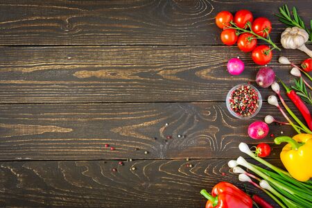 Tasty juicy ripe vegetables with spices on wooden background, vegetable background, healthy eating conceptの写真素材