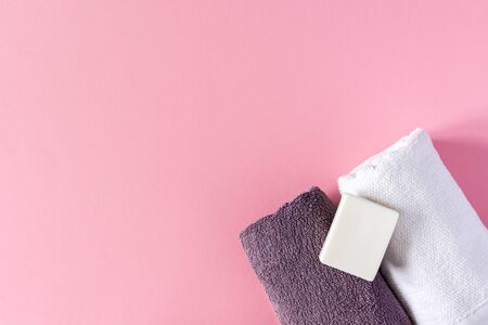 Towels with soap on a pink background, bath spa accessoriesの写真素材