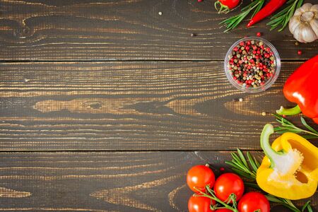 Tasty juicy ripe vegetables with spices on wooden background, vegetable background, healthy eating conceptの写真素材