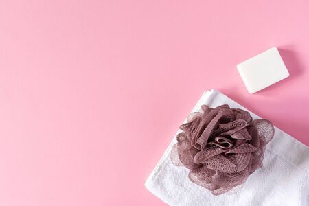 White towel with washcloth and soap on a pink background, bath spa accessoriesの写真素材