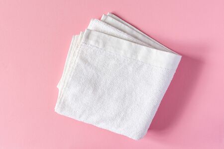 White towel on a pink background, bath spa accessoriesの写真素材