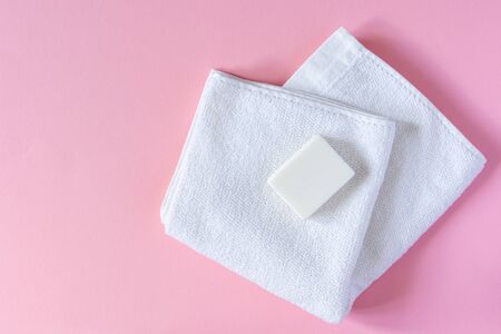 White towel with soap on a pink background, bath spa accessoriesの写真素材
