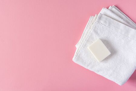 White towel with soap on a pink background, bath spa accessoriesの写真素材