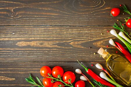 Tasty juicy ripe vegetables and olive oil with spices on a wooden background, vegetable background, healthy eating conceptの写真素材