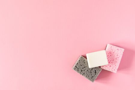 Multi-colored cleaning sponges with soap on a pink background, housekeeping and cleaning conceptの写真素材