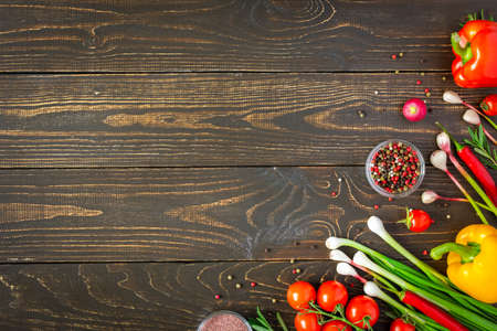 Tasty juicy ripe vegetables with spices on wooden background, vegetable background, healthy eating conceptの写真素材