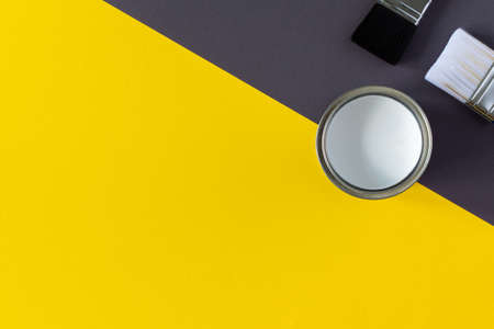 Can of white paint with brushes on colorful background, painting, top viewの写真素材