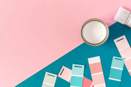 Can of white paint with brush on colorful background, selection of palette for painting, sample color catalog, top viewの写真素材