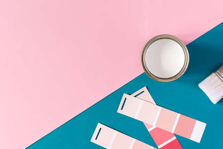 Can of white paint with brush on colorful background, selection of palette for painting, sample color catalog, top viewの写真素材