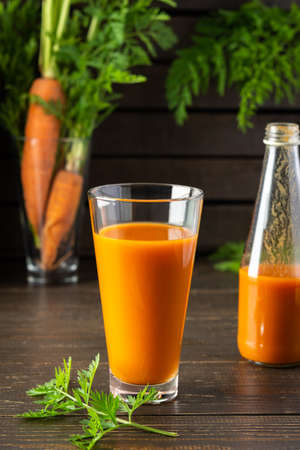 Natural carrot juice with pulp sugar-free in glasses on a wooden tableの写真素材