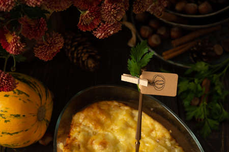 Pumpkin frittata with mozzarella, omelette in a glass dish baked with cheese in the oven on a wooden backgroundの写真素材