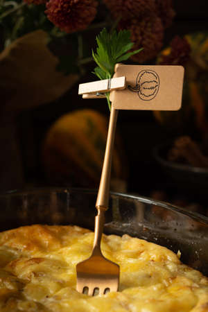 Pumpkin frittata with mozzarella, omelette in a glass dish baked with cheese in the oven on a wooden backgroundの写真素材