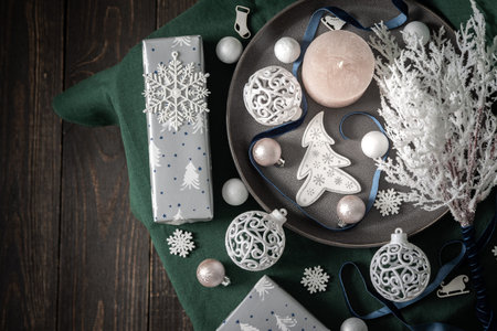Christmas composition in white ,green and gray shades, christmas balls and candle, fir-tree and...