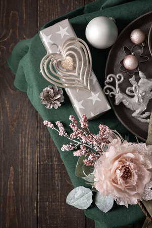 Christmas composition in sail champagne ,green and gray shades, christmas balls and candle, cookie cutters and decorative flower on a green tablecloth, top view, copy spaceの写真素材