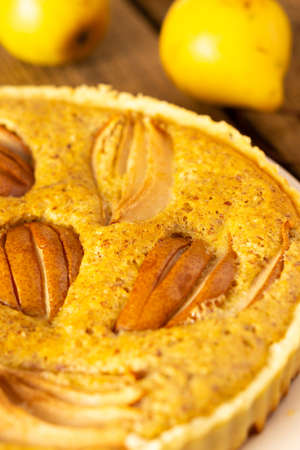 Delicious pear pie from yellow pears on a wooden background close-up, rustic styleの写真素材
