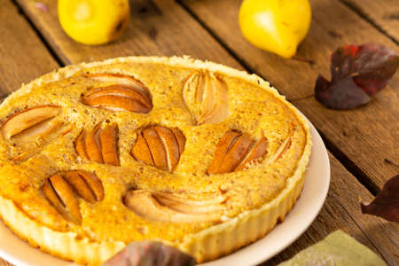 Delicious pear pie from yellow pears on a wooden background close-up, rustic styleの写真素材