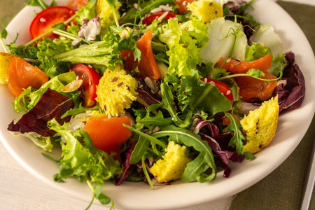 Light breakfast or dinner, mix salad with salmon and different seeds, plate with salad and cornbread close upの写真素材