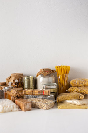 Home food supplies, necessary food for the period of quarantine and isolation, the concept of stay at home, canned food and cereals, various pasta and flour, sugar and cookies, honey and coffeeの写真素材