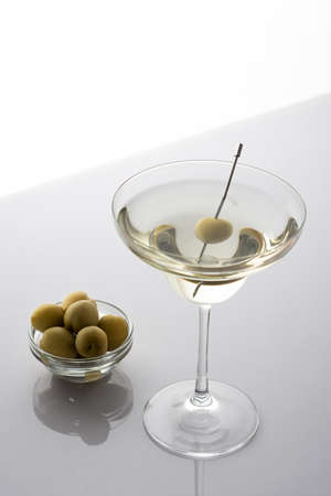 Vermouth in a cocktail glass with olives on a gray background, slightly alcoholic drinkの写真素材