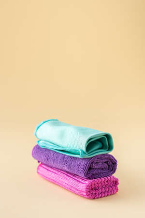Multicolored microfiber cloths for washing on a neutral beige background, cleaning conceptの写真素材