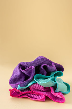 Multicolored microfiber cloths for washing on a neutral beige background, cleaning conceptの写真素材