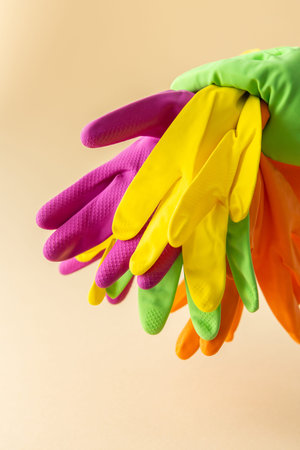 Multicolored working rubber gloves to protect hands while washing close up, cleaning concept